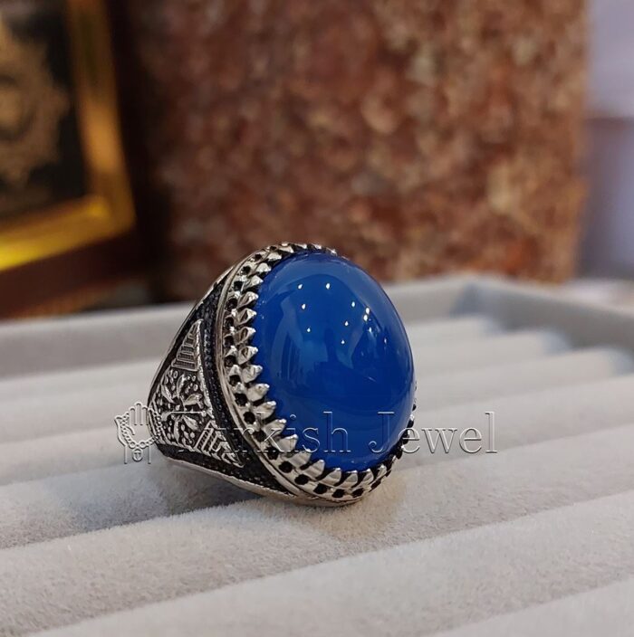Natural Blue Agate Blue Aqeeq Stone Ring 925 Silver 15 e1692046687923 Turkish Jewel <h3>Hand Engraved - Blue Agate</h3> Superior Quality Handmade Design on Sides. Pure and Natural Blue Aqeeq (Blue Agate) stone. Heavy and strong ring made with 925 Silver metal. <p class="LC20lb MBeuO DKV0Md">⭐ Highest Quality Silver 925</p> ⭐ Durable & Strong Design <p class="LC20lb MBeuO DKV0Md">⭐ Lifetime Silver Gurantee</p>