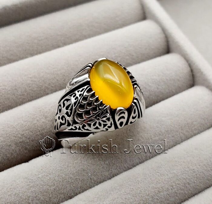 Yellow Agate Aqeeq Stone Ring in real silver (4) Yellow Agate Aqeeq Stone Ring in real silver 4 e1692055999628 Turkish Jewel <h3>Hand Engraved - Yellow Agate</h3> Superior Quality Handmade Design on Sides. Pure and Natural Yellow Aqeeq (Sabz Agate) stone. Heavy and strong ring made with 925 Silver metal. <p class="LC20lb MBeuO DKV0Md">⭐ Highest Quality Silver 925</p> ⭐ Durable & Strong Design <p class="LC20lb MBeuO DKV0Md">⭐ Lifetime Silver Gurantee</p>